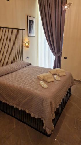 a bedroom with a bed with two towels on it at Il Salotto della Regina in Naples