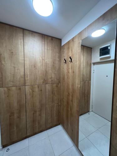 a room with wood paneling and a closet at Apartman 23 Lux in Banja Luka