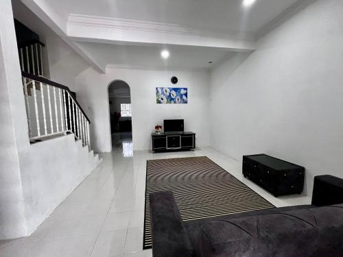 a living room with a couch and a television at DH Homestay in Sungai Petani