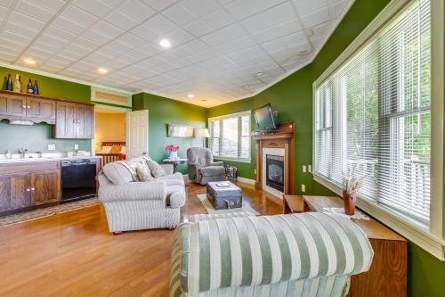 a living room with green walls and a couch and chairs at Amish Country Getaway with Pastoral Views! in Millersburg