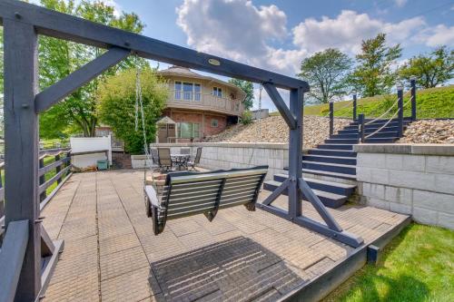 a bench on a patio with a house in the background at Amish Country Getaway with Pastoral Views! in Millersburg