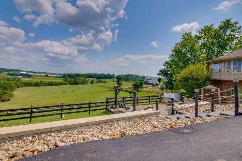 a house with a view of a field at Amish Country Getaway with Pastoral Views! in Millersburg