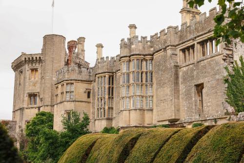 an old castle with a hedge in front of it at Thornbury Castle - A Relais & Chateaux Hotel in Thornbury