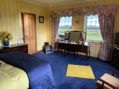 a bedroom with a bed and a desk and a mirror at Arney Lodge Farm in Newtownstewart
