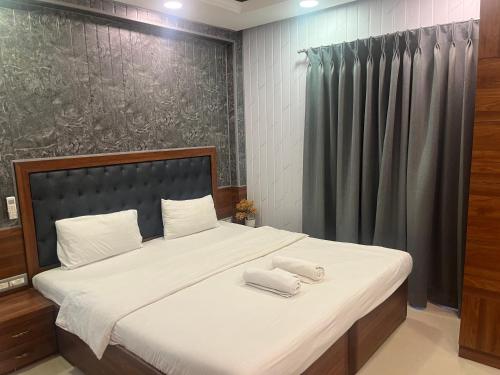 a bedroom with a bed with two towels on it at Areia De Goa, Comfort Stay Apartment near Baga Beach in Baga