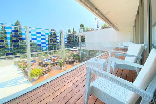 a balcony with chairs and a view of a patio at Eden Reserve Hotel in Gardone Riviera