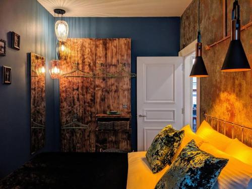 a bedroom with a bed with yellow pillows at Boutique City Centre Flat by City SuperHost in Manchester