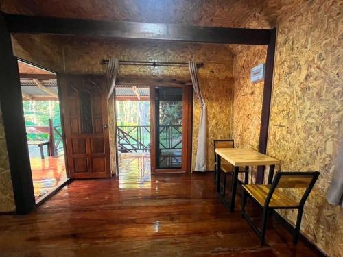 a room with a wooden table and a wooden door at Koh Jum Hillside Resort in Ban Ko Phrao