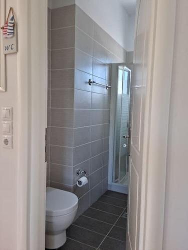 a bathroom with a toilet and a glass shower at Stunning View Villa in Sami in Chaliotata