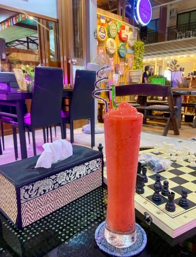 a drink sitting on top of a chess board at Sue@Cozy Guesthouse in Kata Beach