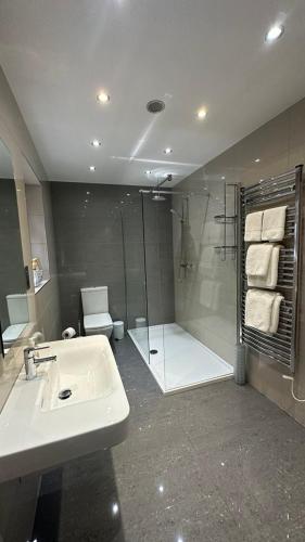 a bathroom with a sink and a shower at Myrtle Bank Guest House in Fort William