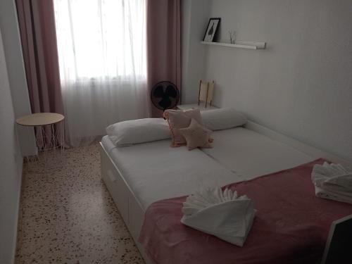 a bedroom with two beds and a window at Apartamento Mar y Arena in Cullera