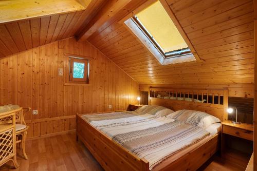 a bedroom with a large bed in a wooden room at Ferienhaus Moritzburg in Moritzburg