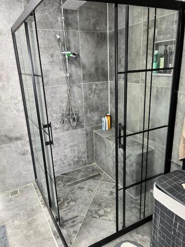 a shower with a glass door in a bathroom at Villa with private pool and sea view in Dikili