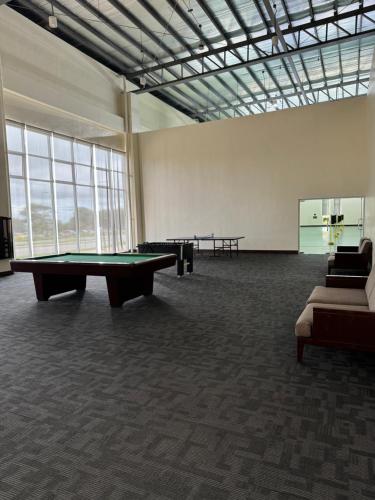 a large room with a pool table and two tables at Wind Residences Tagaytay Tower 3 in Galicias