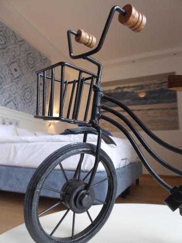 a black bike lamp with a bed in the background at Romantik Hotel Achterdiek in Juist