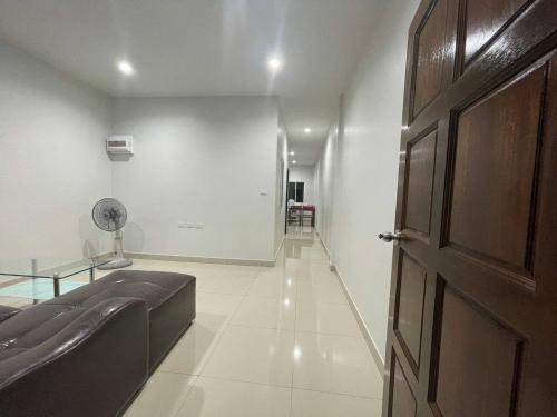 a room with a door and a hallway with a couch at Baan Rawee in Ao Nang 