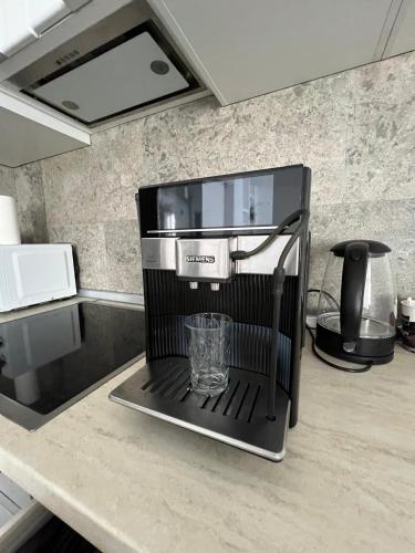 a coffee maker on a counter in a kitchen at Luxus Cluj Airport Apartments in Cluj-Napoca