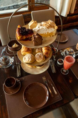 a plate of pastries and biscuits on a table at Arrayan Lake View Mountain Lodge & Casa De Te Arrayan in San Martín de los Andes