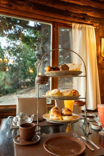 a table with two tiers of pastries on a table at Arrayan Lake View Mountain Lodge & Casa De Te Arrayan in San Martín de los Andes
