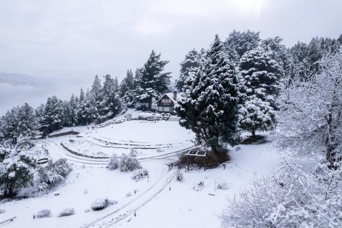 a house on a hill covered in snow at Arrayan Lake View Mountain Lodge & Casa De Te Arrayan in San Martín de los Andes