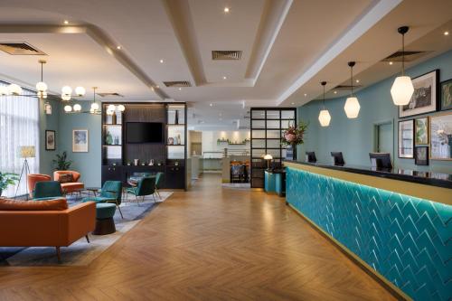 a lobby of a hotel with a blue wall at DoubleTree by Hilton London Chelsea in London