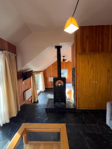a living room with a wood stove in it at Arrayan Lake View Mountain Lodge & Casa De Te Arrayan in San Martín de los Andes