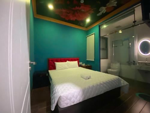 a small bedroom with a bed and a bathroom at Sakura Hotel Thủ Đức in Ho Chi Minh City