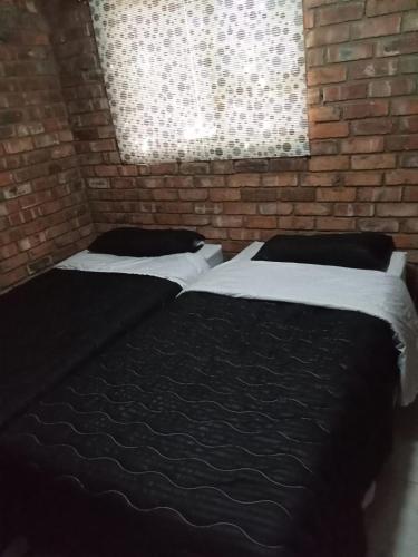 Ένα ή περισσότερα κρεβάτια σε δωμάτιο στο Secunda BackPackers