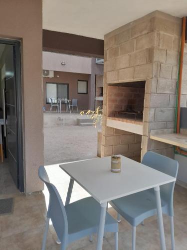 a table and chairs in a room with a fireplace at Acacias Mina Clavero in Mina Clavero