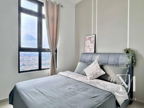 a bedroom with a bed with a large window at Parkland Batu11 2BR MRT Free Parking #22 in Cheras