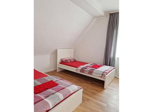 a bedroom with two beds in a attic at Wohnung Beth im Dachgeschoss mit Balkon in Lonnerstadt