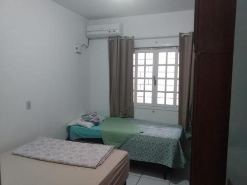 Katil atau katil-katil dalam bilik di Casa na praia Ubatuba Enseada