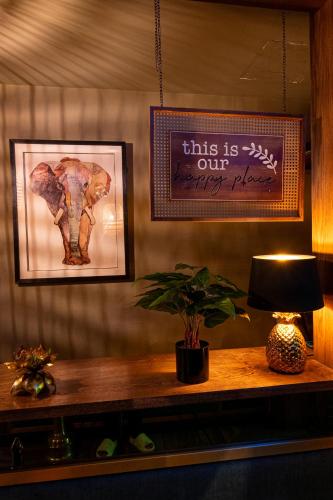 a table with a lamp and a picture of an elephant at President Hotel in Dubai