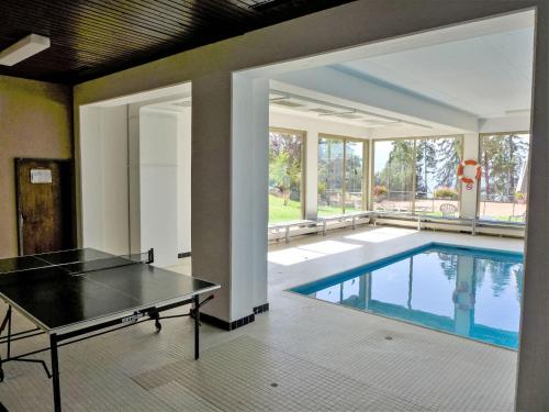 an indoor pool with a ping pong table in a house at Apartment Cransalpin Apt- 3 - Secteur 1 by Interhome in Vermala