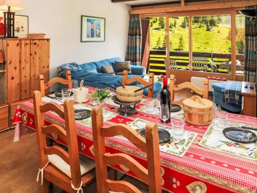 a living room with a table with a red table cloth at Apartment Rosablanche D51 by Interhome in Siviez