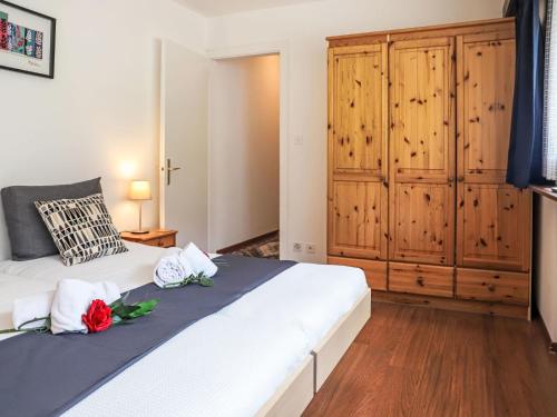 a bedroom with a bed with two roses on it at Apartment Rosablanche C21 by Interhome in Siviez