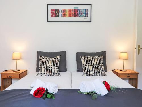 a bedroom with a bed with two roses on it at Apartment Rosablanche C21 by Interhome in Siviez