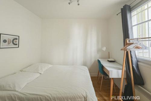 une chambre avec un lit, un bureau et une fenêtre dans l'établissement Flexliving - room - Banquier, à Paris