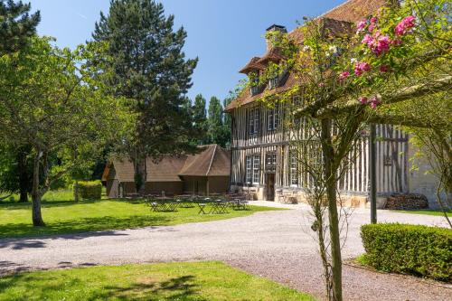 a building with a tree in front of it at Les Manoirs des Portes de Deauville - Small Luxury Hotel Of The World in Deauville