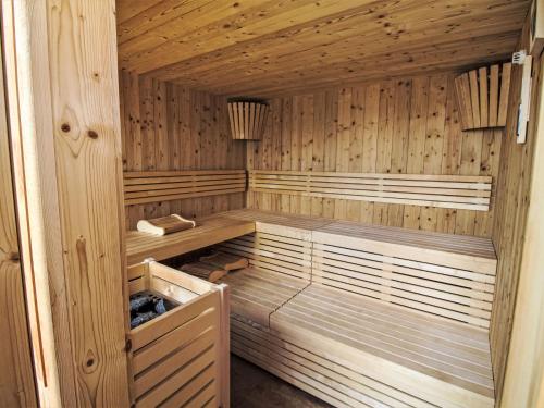 an empty sauna with wooden walls and wooden floors at Chalet Panorama by Interhome in Klippitztorl