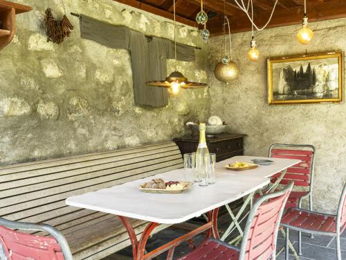 a table in a restaurant with a white table and chairs at Apartment Grangettes-1 by Interhome in Noville