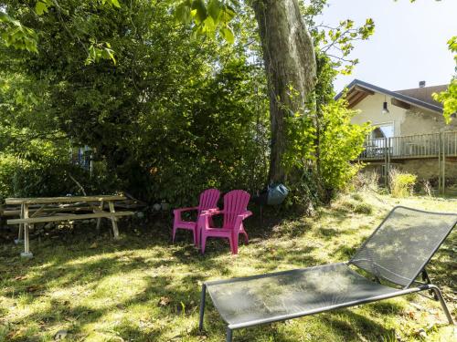 two purple chairs and a picnic table in a yard at Apartment Grangettes-1 by Interhome in Noville