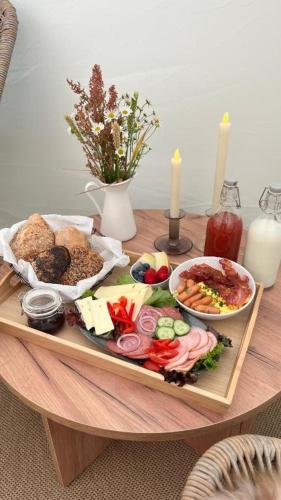 a tray of food sitting on a table with food at Agger Glamping - Vesterhavet in Tåbel