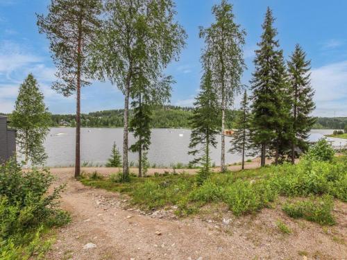 a view of a lake with trees in the foreground at Holiday Home Skivillas 47 ukkohalla - a3 by Interhome in Hyrynsalmi