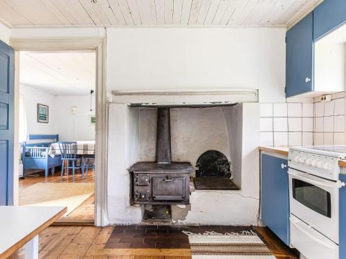 an open kitchen with a stove in the middle at Holiday Home Svenstorp by Interhome in Ryssby
