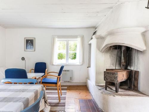 a bedroom with a bed and an oven in a room at Holiday Home Svenstorp by Interhome in Ryssby
