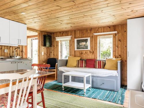 a living room with a couch and a table at Holiday Home Svenstorp by Interhome in Ryssby