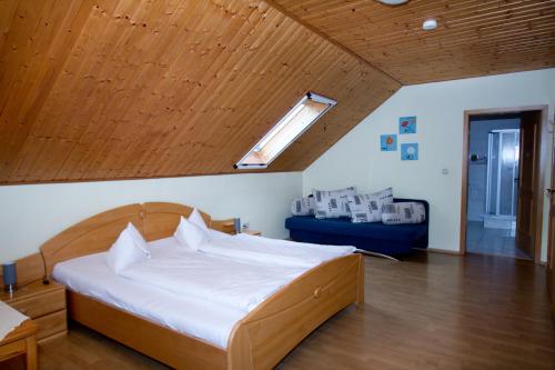 a bedroom with a large bed with a wooden ceiling at Ferienpension Kühner in Römhild