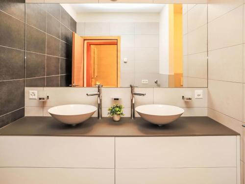 two sinks on a counter in a bathroom at Apartment Rosablanche D 204 A by Interhome in Siviez